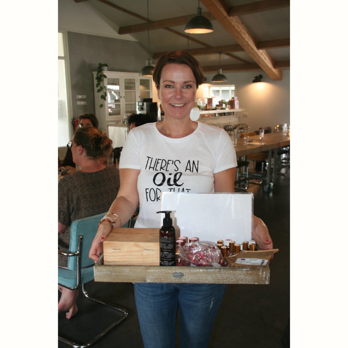 Suzanne presenteert een tray met essentiële olieproducten tijdens een consult of workshop.