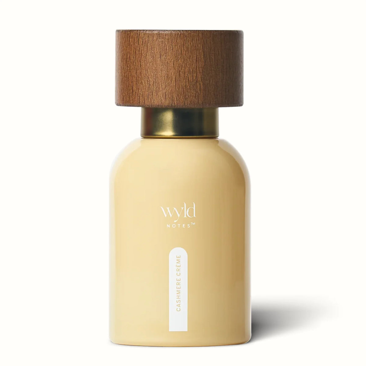 Wyld Notes Cashmere Crème parfumfles met crèmekleurige flacon, houten dop en gouden detail.